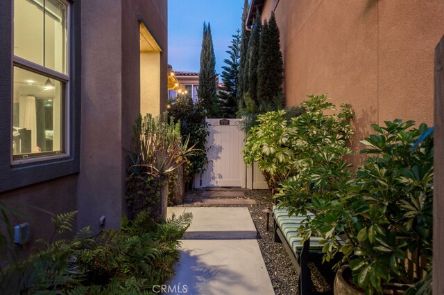 exterior space featuring a gate and stucco siding