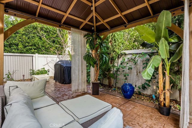 view of patio with a gazebo, area for grilling, a fenced backyard, and an outdoor living space