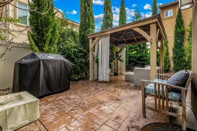 view of patio featuring area for grilling, an outdoor living space, and a gazebo