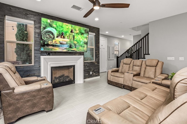 living room with a fireplace, recessed lighting, visible vents, ceiling fan, and stairs