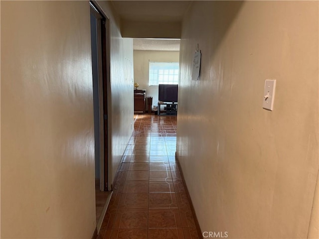 hall featuring dark tile patterned floors