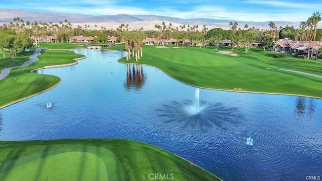 exterior space with view of golf course and a water and mountain view