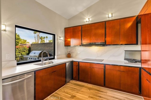 kitchen featuring black electric cooktop, under cabinet range hood, a sink, stainless steel dishwasher, and decorative backsplash