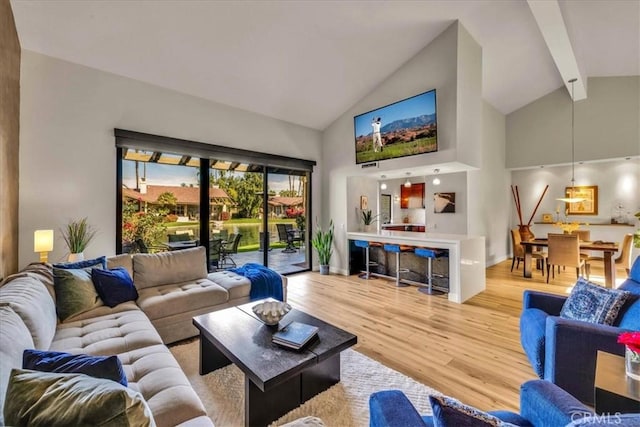 living room with high vaulted ceiling, wood finished floors, and beam ceiling