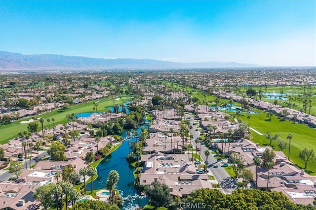 drone / aerial view with a residential view, view of golf course, and a water and mountain view