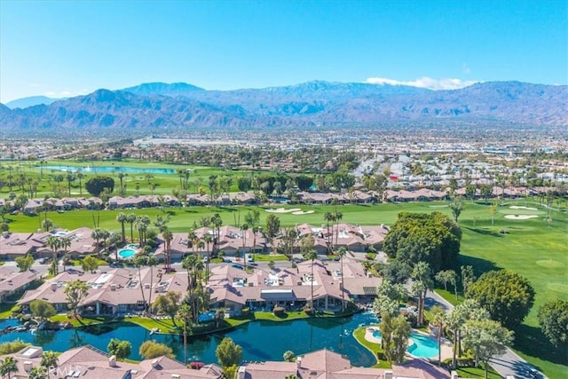 bird's eye view with view of golf course, a water and mountain view, and a residential view