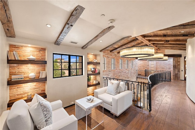 interior space with lofted ceiling with beams, hardwood / wood-style floors, visible vents, and an inviting chandelier