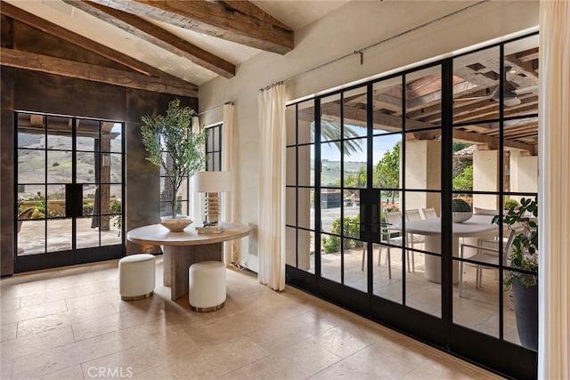 entryway featuring french doors and vaulted ceiling with beams