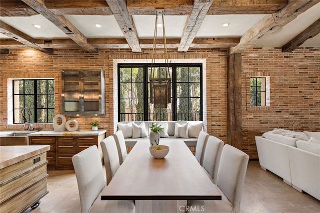 dining room featuring brick wall, coffered ceiling, beam ceiling, and recessed lighting