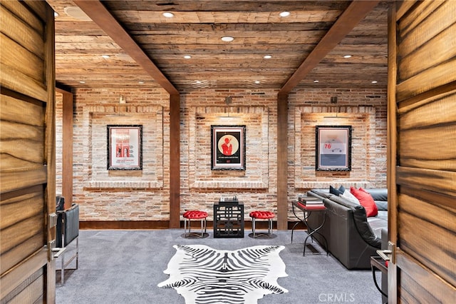 interior space with recessed lighting, beam ceiling, carpet flooring, and brick wall