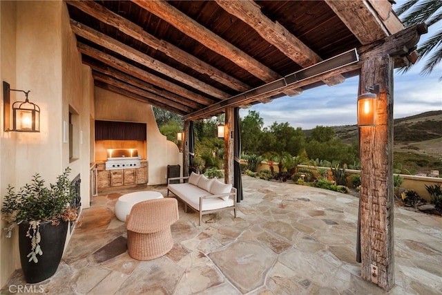 view of patio with an outdoor kitchen and area for grilling