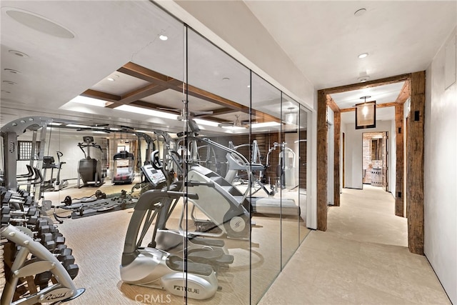 exercise room featuring coffered ceiling