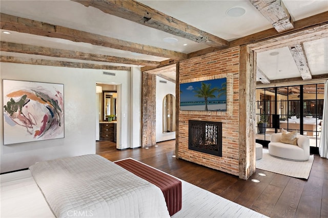 bedroom with hardwood / wood-style flooring, a fireplace, and beamed ceiling