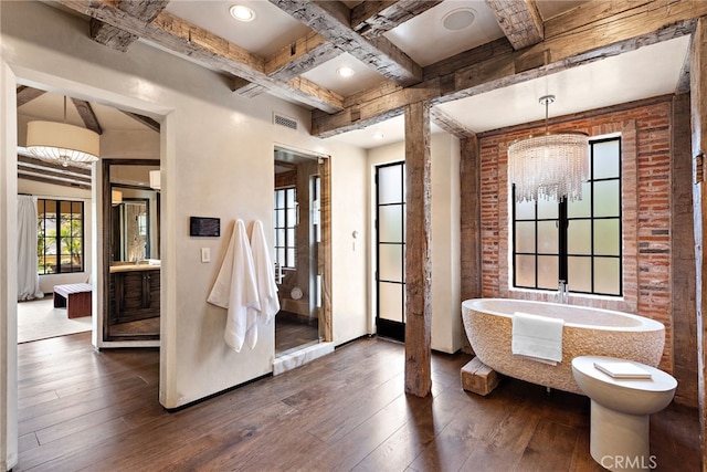 interior space with brick wall, dark wood-style flooring, coffered ceiling, visible vents, and beamed ceiling