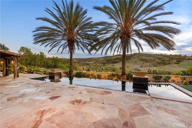 view of patio / terrace featuring a mountain view