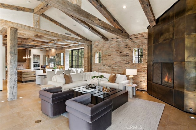 living room featuring brick wall, a fireplace, high vaulted ceiling, and beamed ceiling