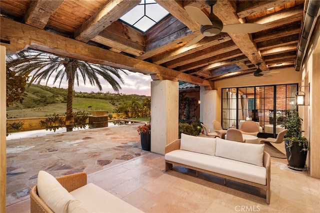 view of patio with ceiling fan and an outdoor hangout area