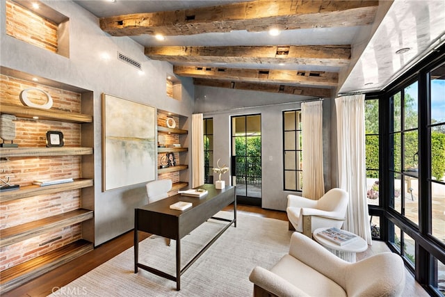 office featuring lofted ceiling with beams, visible vents, and wood finished floors