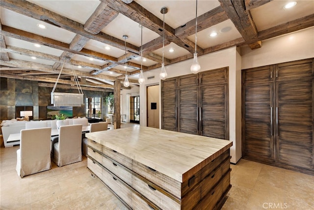 interior space with beam ceiling, recessed lighting, hanging light fixtures, butcher block countertops, and coffered ceiling