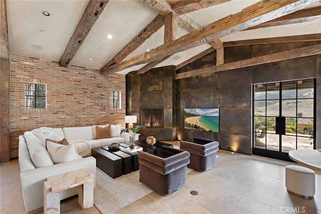 living area with high vaulted ceiling, beam ceiling, a large fireplace, and brick wall