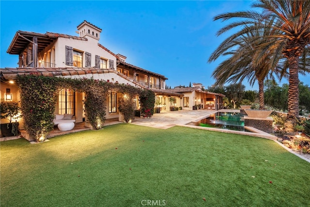 31 Blue Heron, Irvine, CA 92603 - back of property featuring a tile roof, a patio area, stucco siding, a lawn, and an outdoor pool