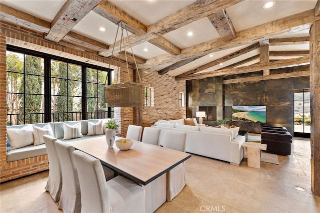 dining room featuring vaulted ceiling with beams, brick wall, a wealth of natural light, and recessed lighting