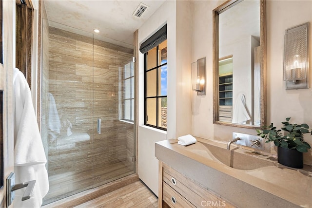 31 Blue Heron, Irvine, CA 92603 - bathroom featuring a shower stall, visible vents, wood finished floors, and vanity