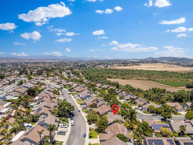 drone / aerial view featuring a residential view and a mountain view