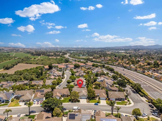 birds eye view of property featuring a mountain view and a residential view