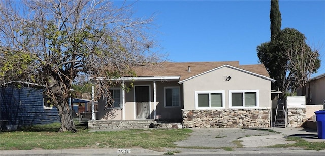 view of front of home with stone siding and stucco siding