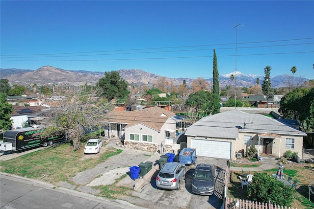 view of front of property featuring driveway, a garage, and a mountain view