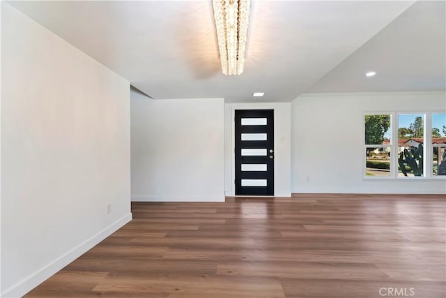 entrance foyer with baseboards and wood finished floors