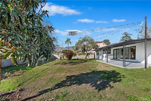 view of yard featuring a patio and fence