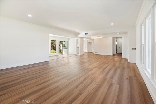 unfurnished living room featuring light wood-style flooring, visible vents, baseboards, and recessed lighting