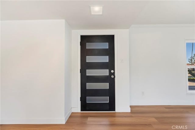 entrance foyer with wood finished floors and baseboards