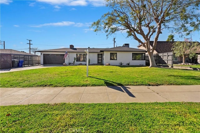 view of front of home featuring a garage, a front yard, concrete driveway, and stucco siding