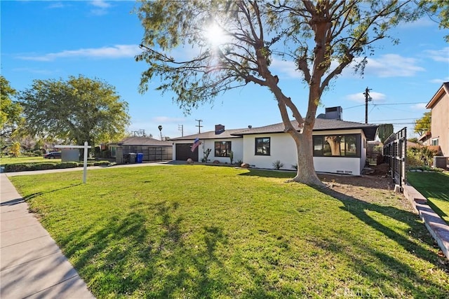 ranch-style home featuring a garage, stucco siding, and a front yard