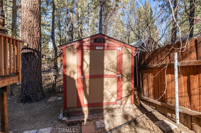 view of shed featuring fence