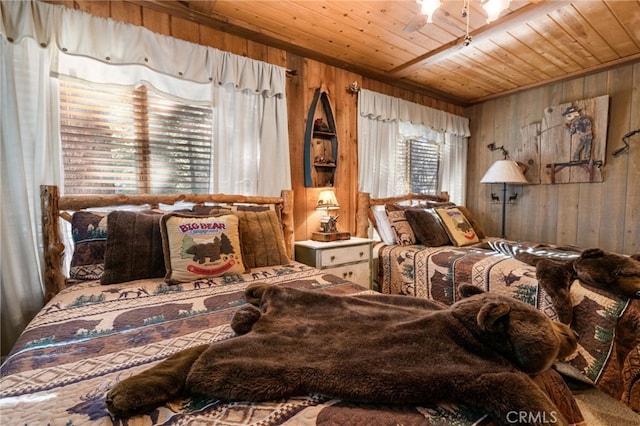 bedroom with wood ceiling and wooden walls