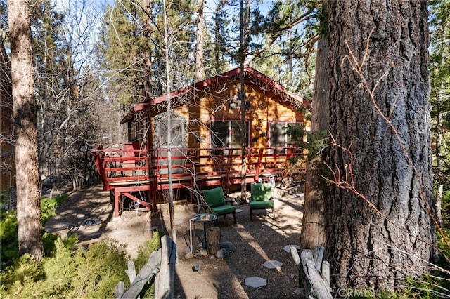 back of house featuring a deck