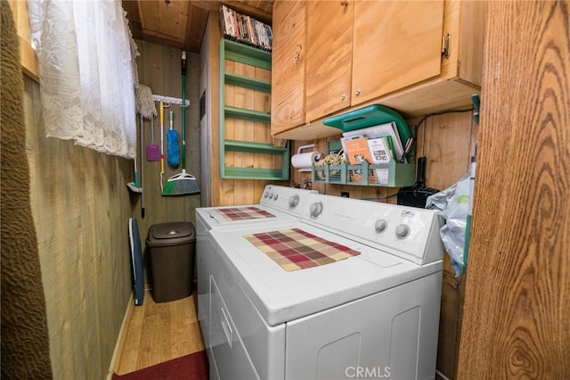 laundry room featuring cabinet space and wood finished floors