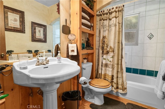 full bathroom with toilet, shower / bath combination with curtain, and wood finished floors