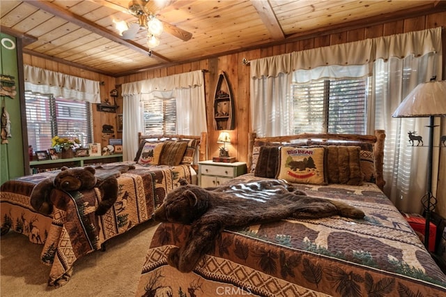 carpeted bedroom featuring multiple windows, wood walls, and wood ceiling