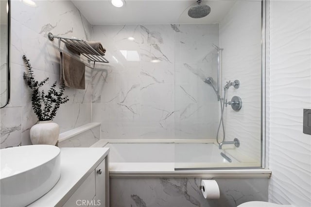 bathroom with a marble finish shower and vanity