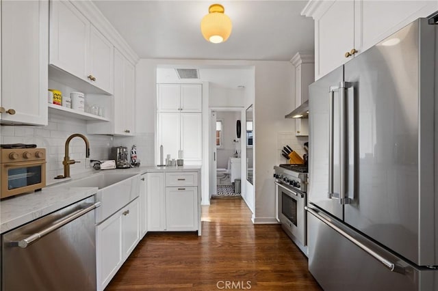 kitchen with premium appliances, dark wood-style floors, open shelves, visible vents, and white cabinets