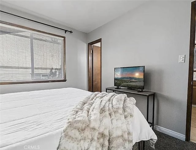 bedroom featuring carpet floors and baseboards