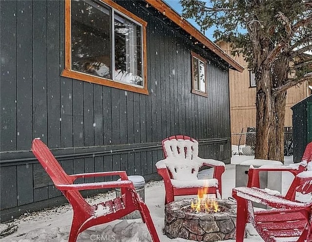 view of patio featuring an outdoor fire pit and fence