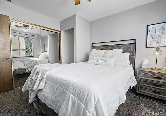 bedroom with dark colored carpet, a closet, and a ceiling fan