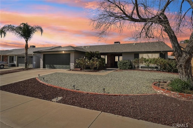 view of front facade featuring driveway and an attached garage