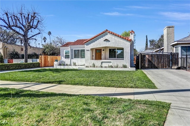 mediterranean / spanish-style house featuring a front lawn, a tile roof, fence, and stucco siding